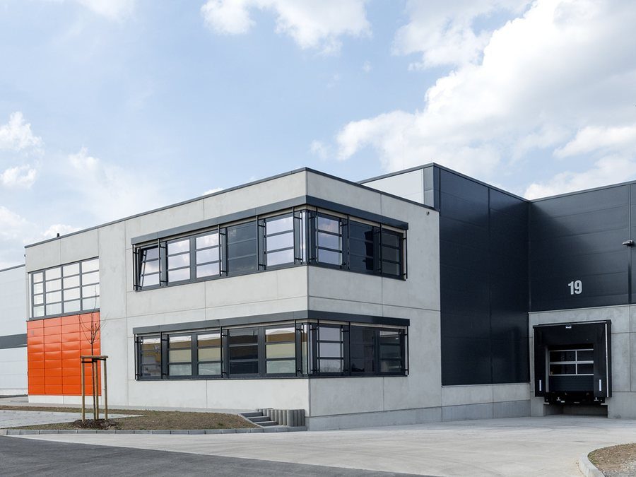 Moderne Logistikhalle mit Bürokopf und Verladetoren
